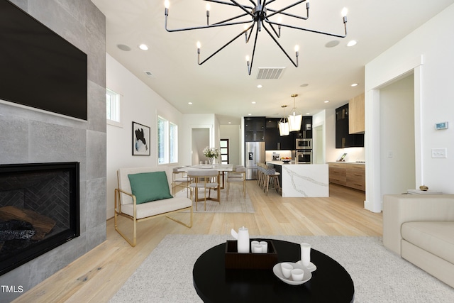 living room featuring a fireplace and light hardwood / wood-style flooring