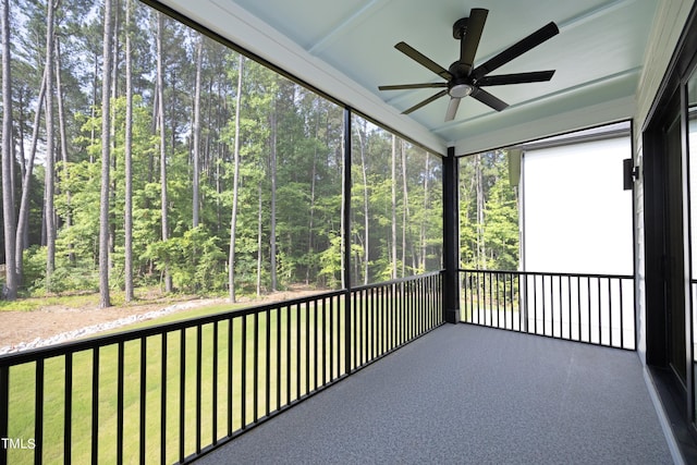 unfurnished sunroom featuring ceiling fan