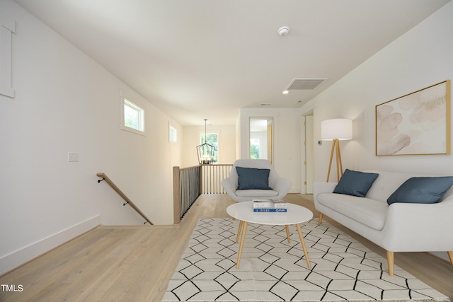 living room featuring a chandelier and light hardwood / wood-style floors