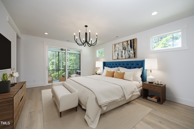 bedroom with an inviting chandelier, access to exterior, and light wood-type flooring