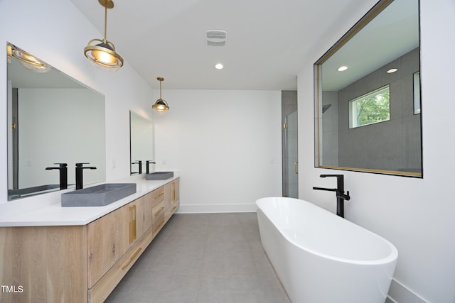 bathroom featuring vanity and separate shower and tub