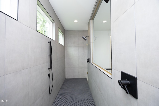 bathroom featuring tile walls and walk in shower