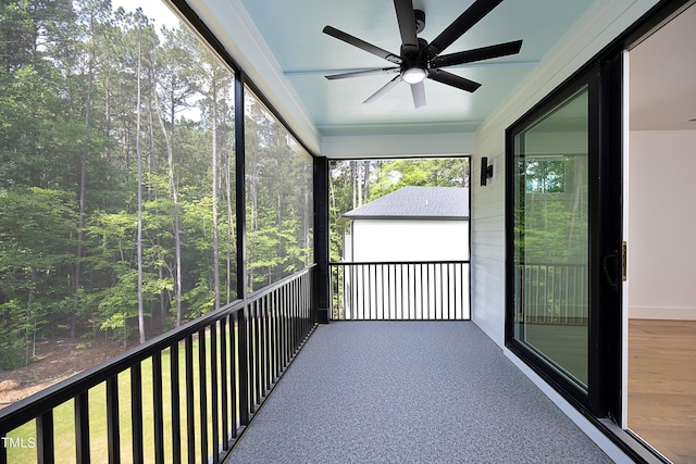 unfurnished sunroom featuring ceiling fan