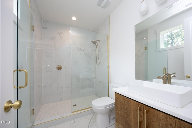 bathroom with vanity, toilet, and a shower with door