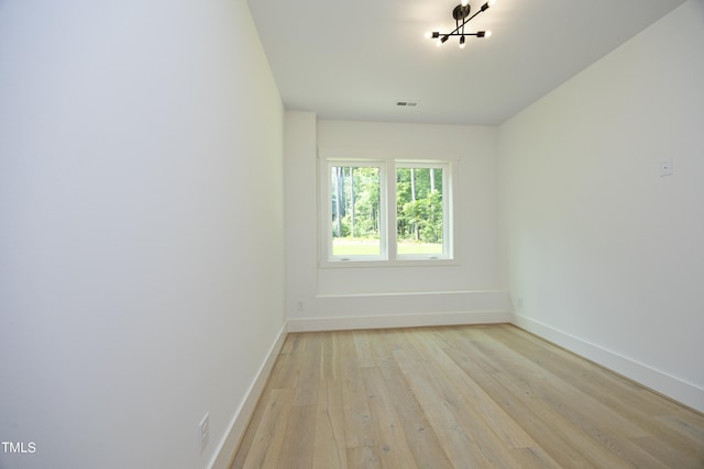 spare room featuring light hardwood / wood-style flooring