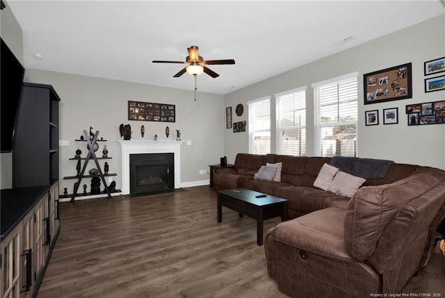 living room with dark wood-type flooring and ceiling fan