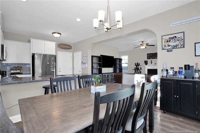 dining space with ceiling fan and light hardwood / wood-style flooring