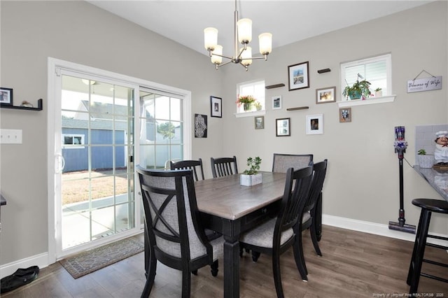 dining room with a chandelier and dark hardwood / wood-style flooring