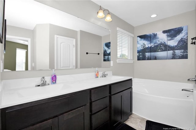 bathroom featuring vanity and a tub