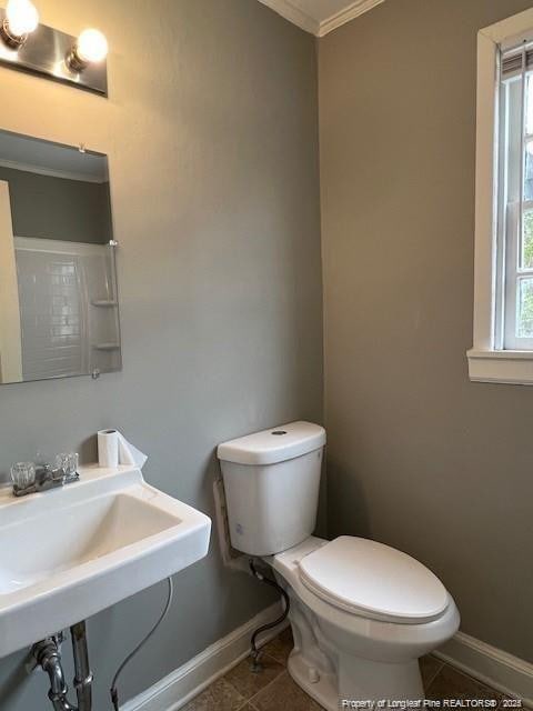 bathroom with sink, tile patterned floors, ornamental molding, and toilet