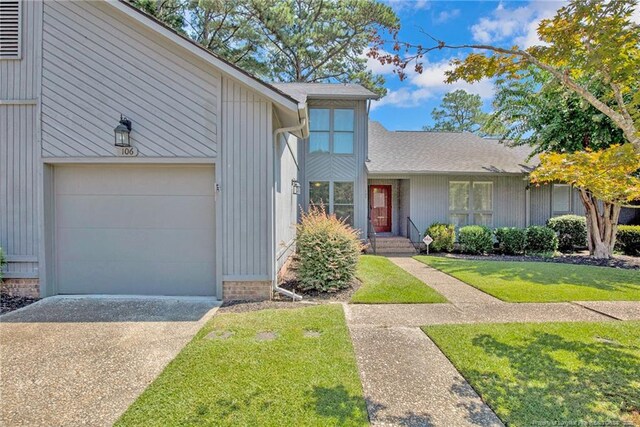 view of front of house with a garage and a front yard