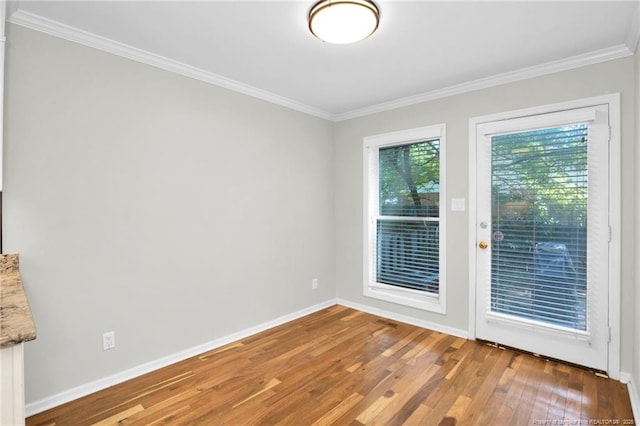 unfurnished room featuring crown molding and wood-type flooring