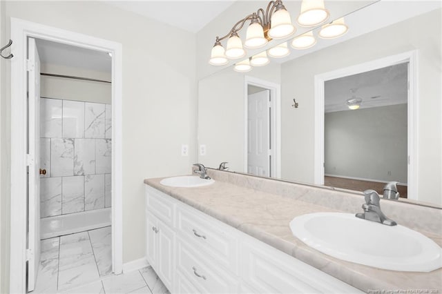 bathroom with vanity, ceiling fan, and a tile shower