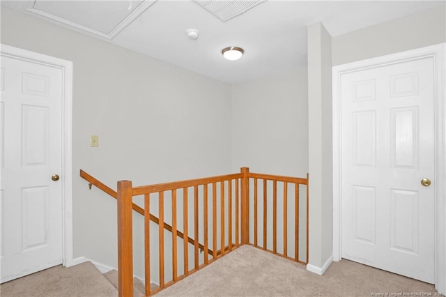 corridor featuring light colored carpet