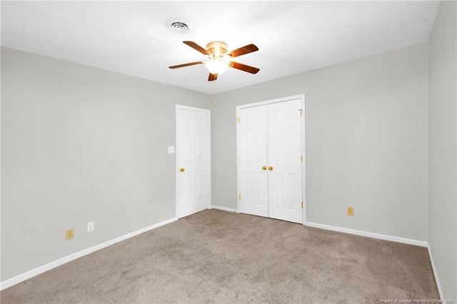 unfurnished bedroom featuring a closet, ceiling fan, and carpet