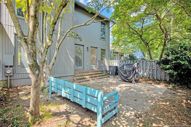 back of house featuring cooling unit