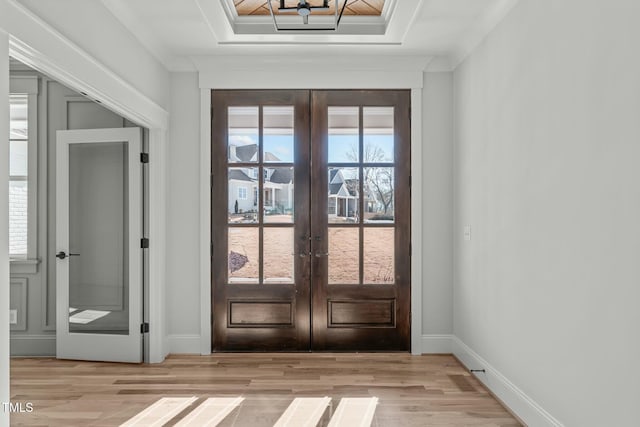 doorway to outside with french doors, ornamental molding, light hardwood / wood-style flooring, and a wealth of natural light