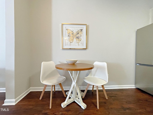 dining room with dark hardwood / wood-style flooring and breakfast area