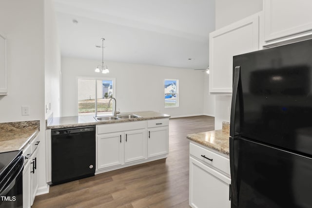 kitchen featuring sink, dark wood-type flooring, white cabinetry, hanging light fixtures, and black appliances