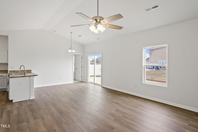 unfurnished living room with dark hardwood / wood-style flooring, sink, vaulted ceiling, and ceiling fan