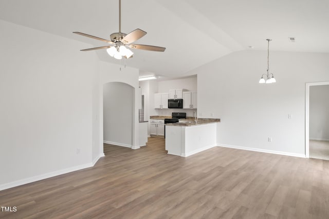 kitchen with black appliances, white cabinetry, lofted ceiling, light hardwood / wood-style floors, and kitchen peninsula