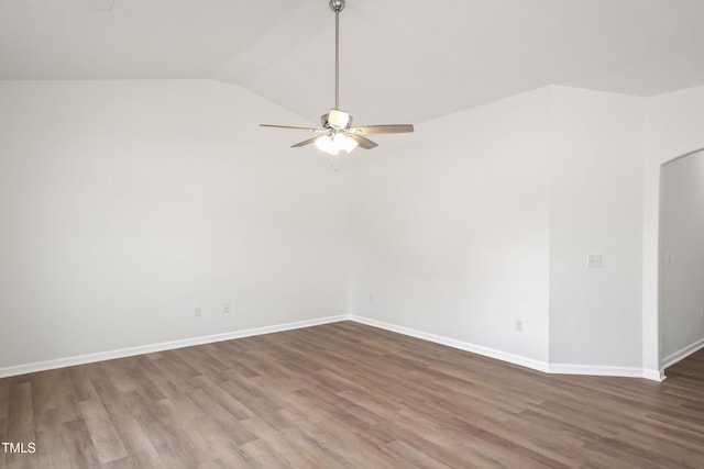 spare room featuring lofted ceiling, dark wood-type flooring, and ceiling fan