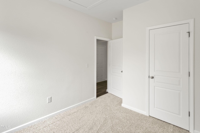 unfurnished bedroom featuring light carpet