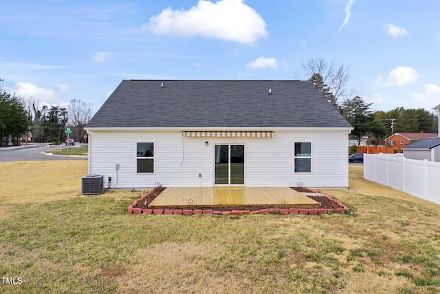 rear view of property featuring a wooden deck, a yard, and central AC unit