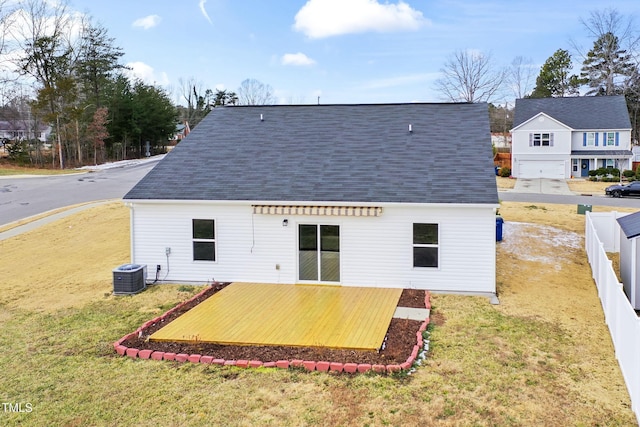 back of property featuring a yard, a deck, and central air condition unit