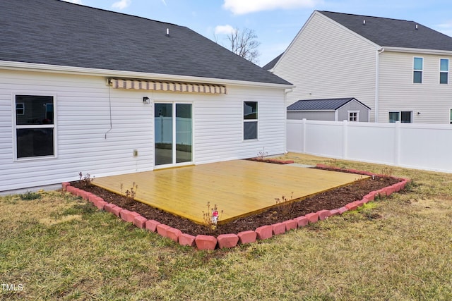 rear view of property with a yard and a deck