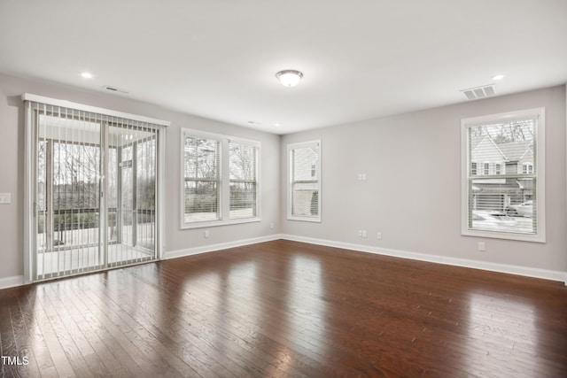 spare room featuring dark wood-type flooring