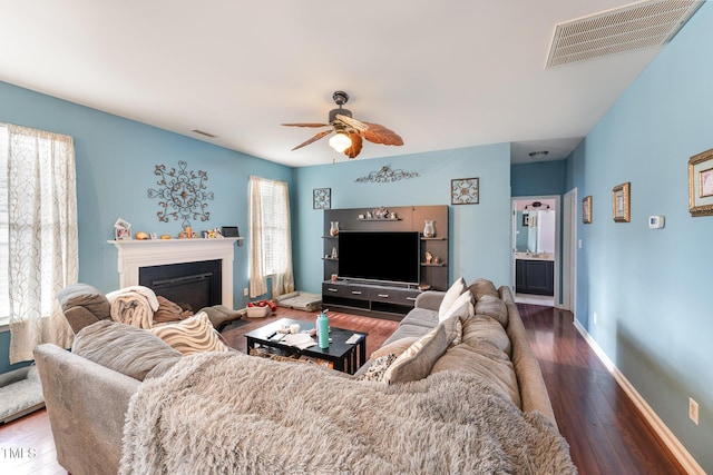 living room featuring hardwood / wood-style flooring, ceiling fan, and plenty of natural light