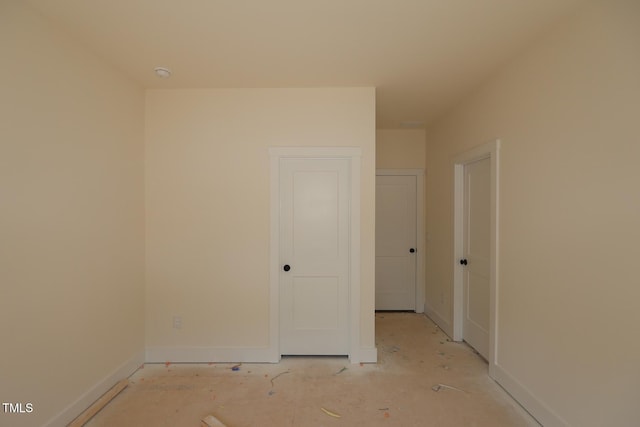 spare room with baseboards and a smoke detector