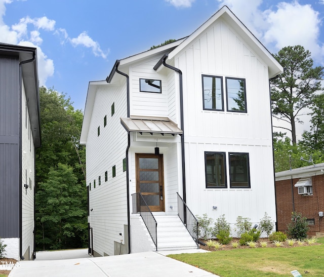 modern inspired farmhouse with a front lawn