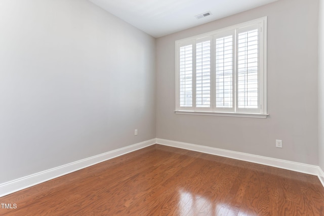 unfurnished room with hardwood / wood-style floors