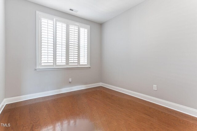 spare room featuring hardwood / wood-style flooring