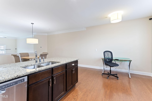 kitchen with sink, dishwasher, light stone counters, light hardwood / wood-style floors, and decorative light fixtures