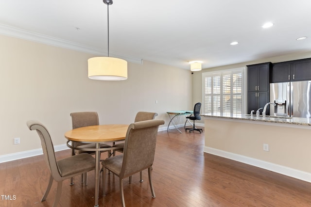 dining area with sink and dark hardwood / wood-style flooring