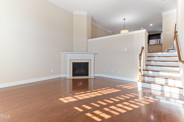 unfurnished living room with crown molding and dark hardwood / wood-style floors