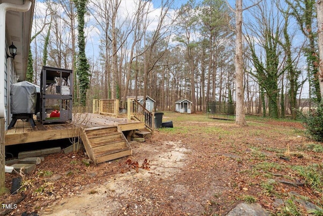 view of yard with a storage unit, an outdoor structure, and a deck