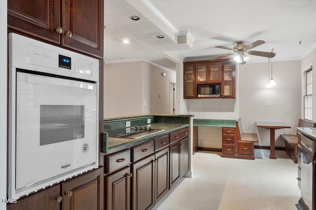 kitchen featuring a ceiling fan, built in microwave, ornamental molding, oven, and black electric stovetop