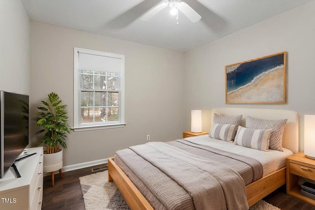 bedroom featuring ceiling fan, visible vents, baseboards, and dark wood finished floors