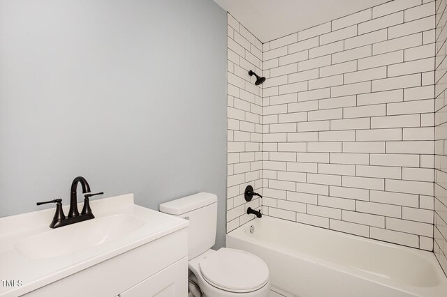 full bathroom with tiled shower / bath, vanity, and toilet