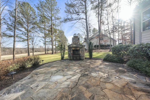 view of patio with an outdoor stone fireplace