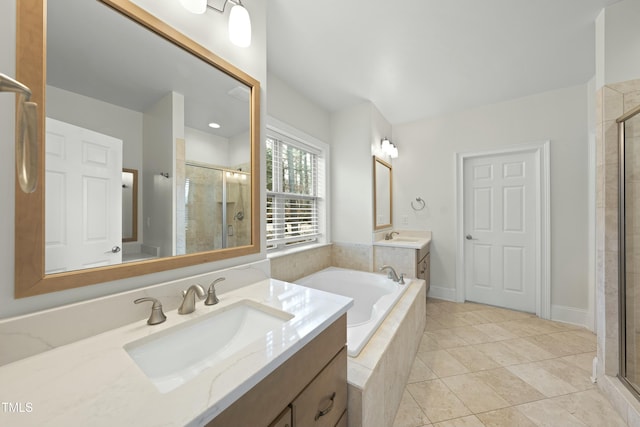 bathroom with tile patterned floors, vanity, and shower with separate bathtub