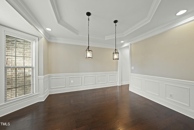 empty room featuring a tray ceiling, ornamental molding, and dark hardwood / wood-style floors