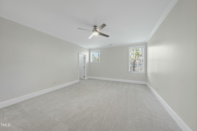 carpeted empty room with ceiling fan and crown molding