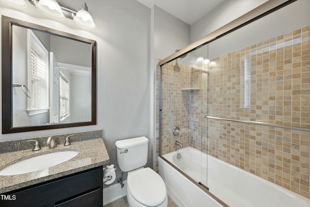 full bathroom with toilet, combined bath / shower with glass door, and vanity