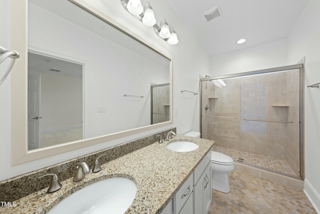 bathroom with an enclosed shower, vanity, and toilet