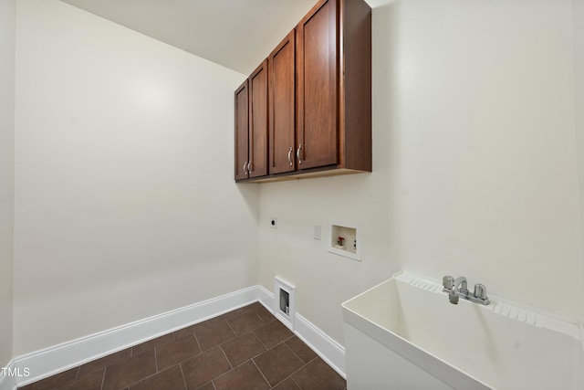 washroom featuring cabinets, dark tile patterned floors, hookup for a washing machine, and electric dryer hookup